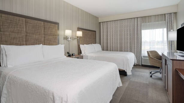 A hotel room with two beds, a desk, a chair, and a TV. - Hampton Inn Collinsville (Collinsville)