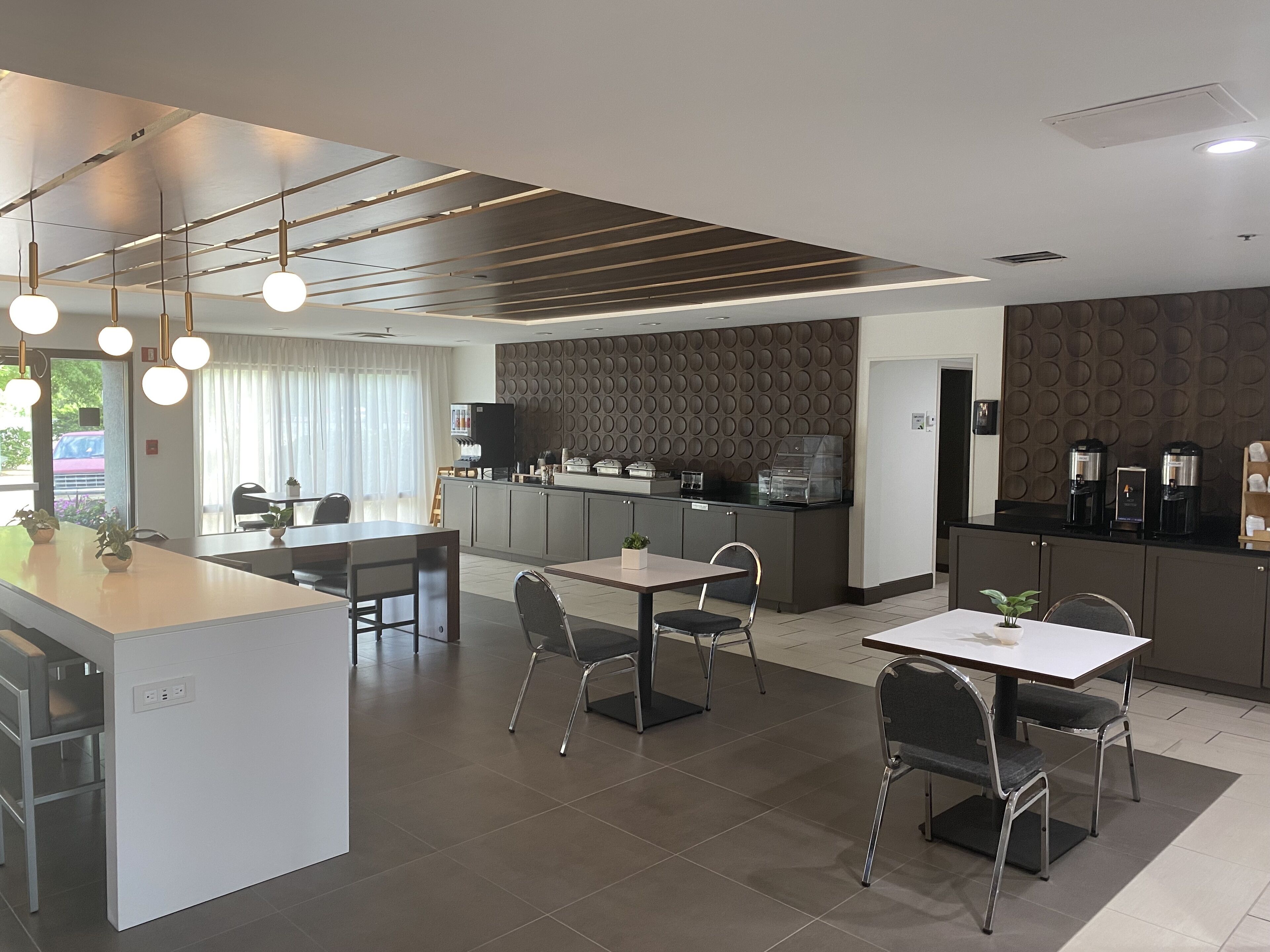 A modern kitchen and dining area with a central island, built-in appliances, and a seating arrangement for guests.