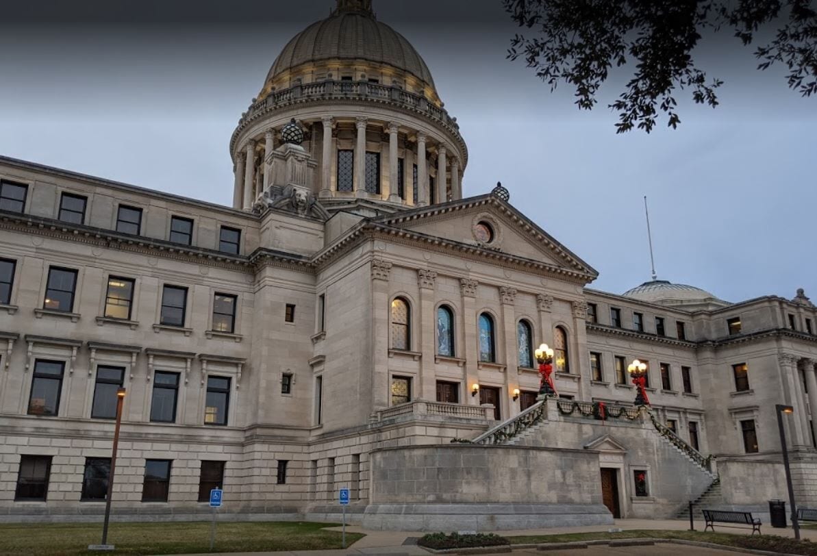 A large, historic building with a prominent dome and classical architecture.