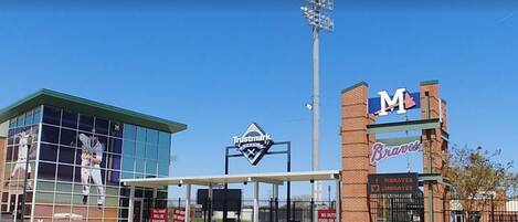 A baseball stadium with a Trustmark sign, a Braves sign, and a Moravese sign.