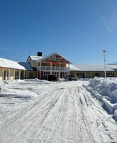 A building with a colorful facade and a snow-covered driveway.