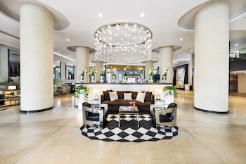 A gym with various exercise equipment, including dumbbells, kettlebells, and cardio machines. at Hotel Riu Plaza Miami Beach
