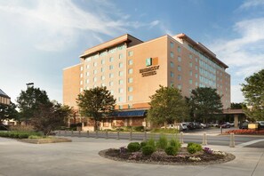 A multi-story hotel with a prominent 'Embassy Suites' sign, a landscaped front yard, and a parking area. - Embassy Suites Charleston (Charleston)