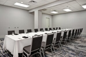 A conference room with a long table, chairs, and a carpeted floor. - Embassy Suites Charleston (Charleston)