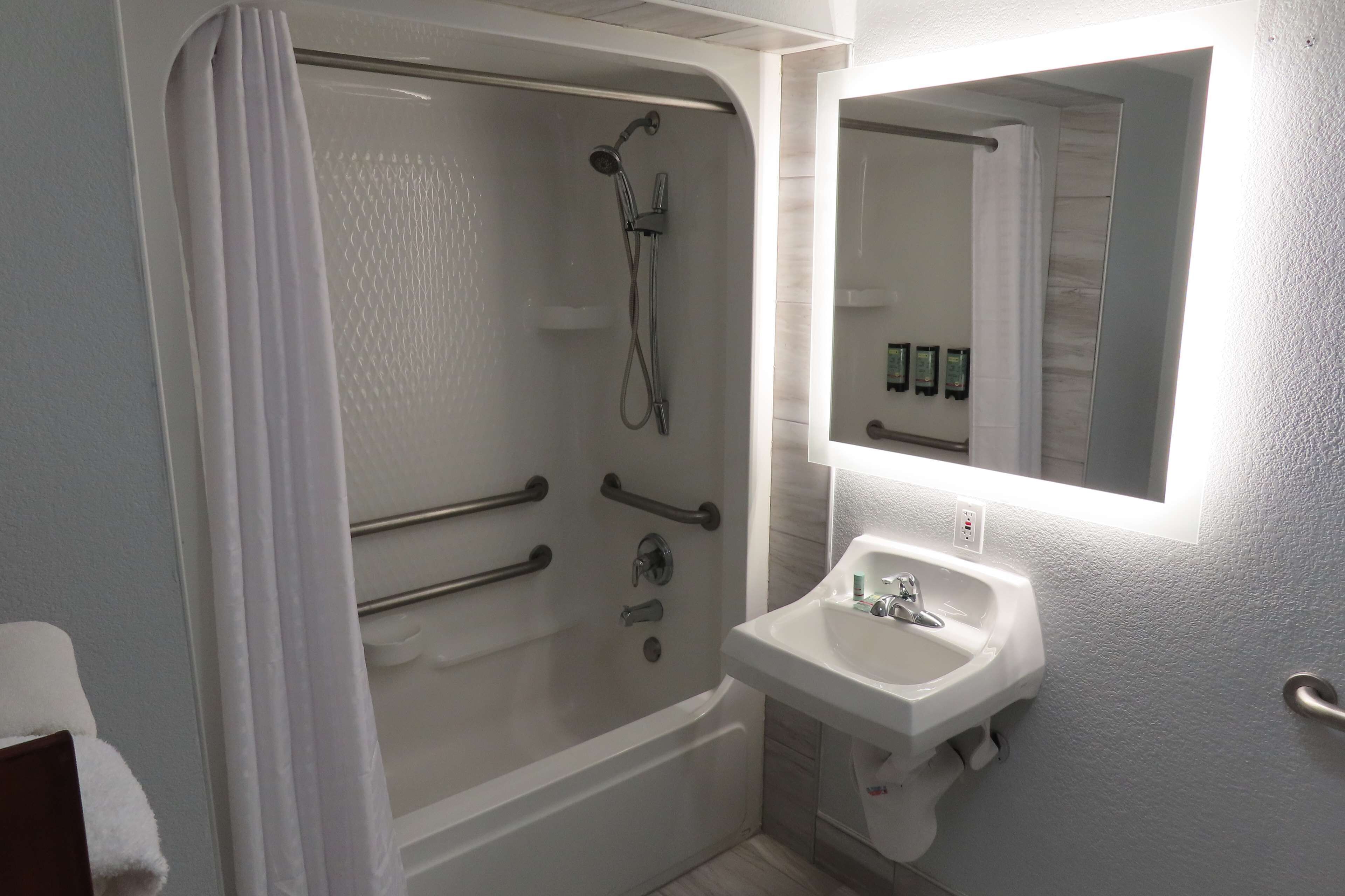 Une salle de bain avec une baignoire, une douche et un lavabo.