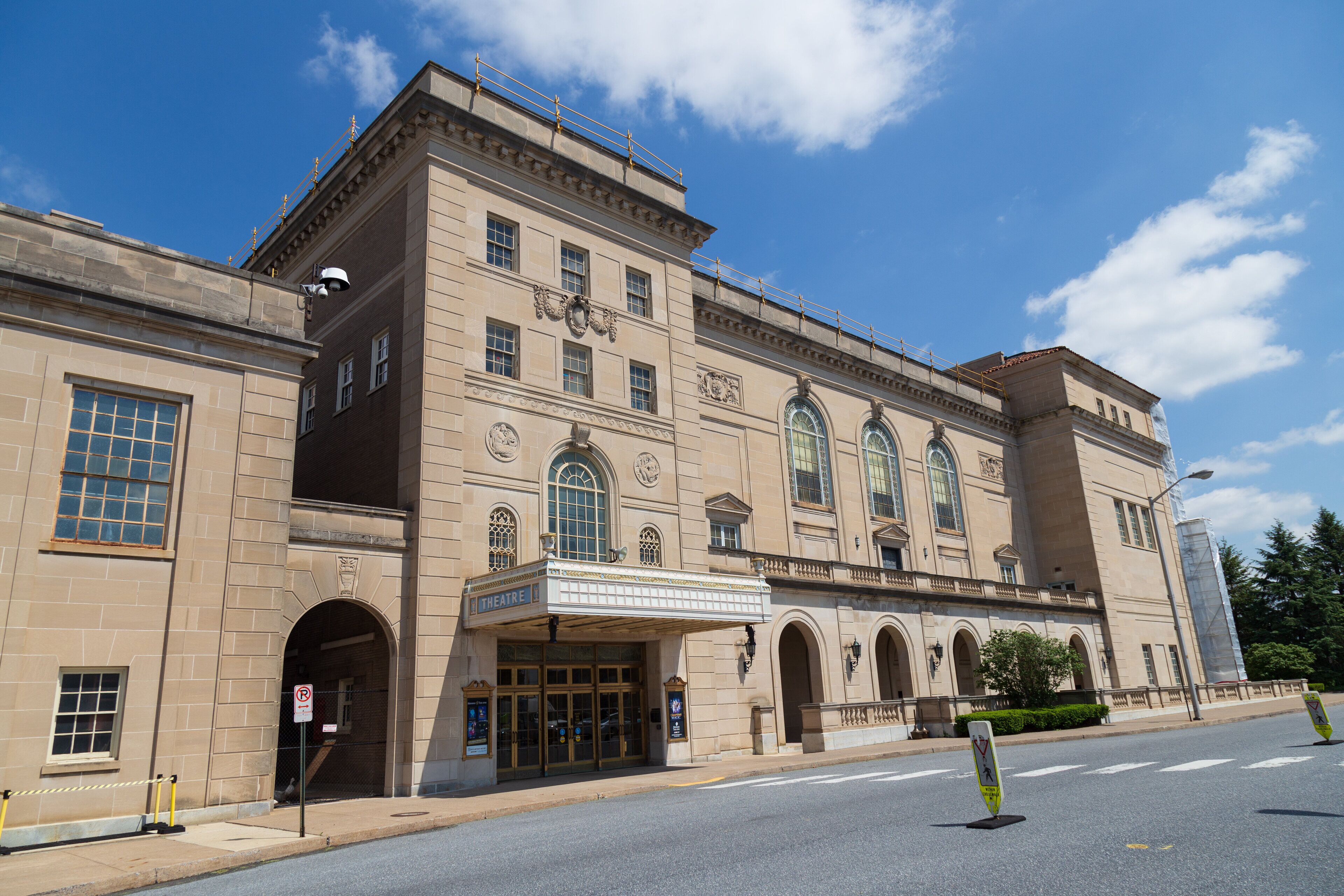 A historic theater building with a classic architectural style, featuring arched windows and a grand entrance.