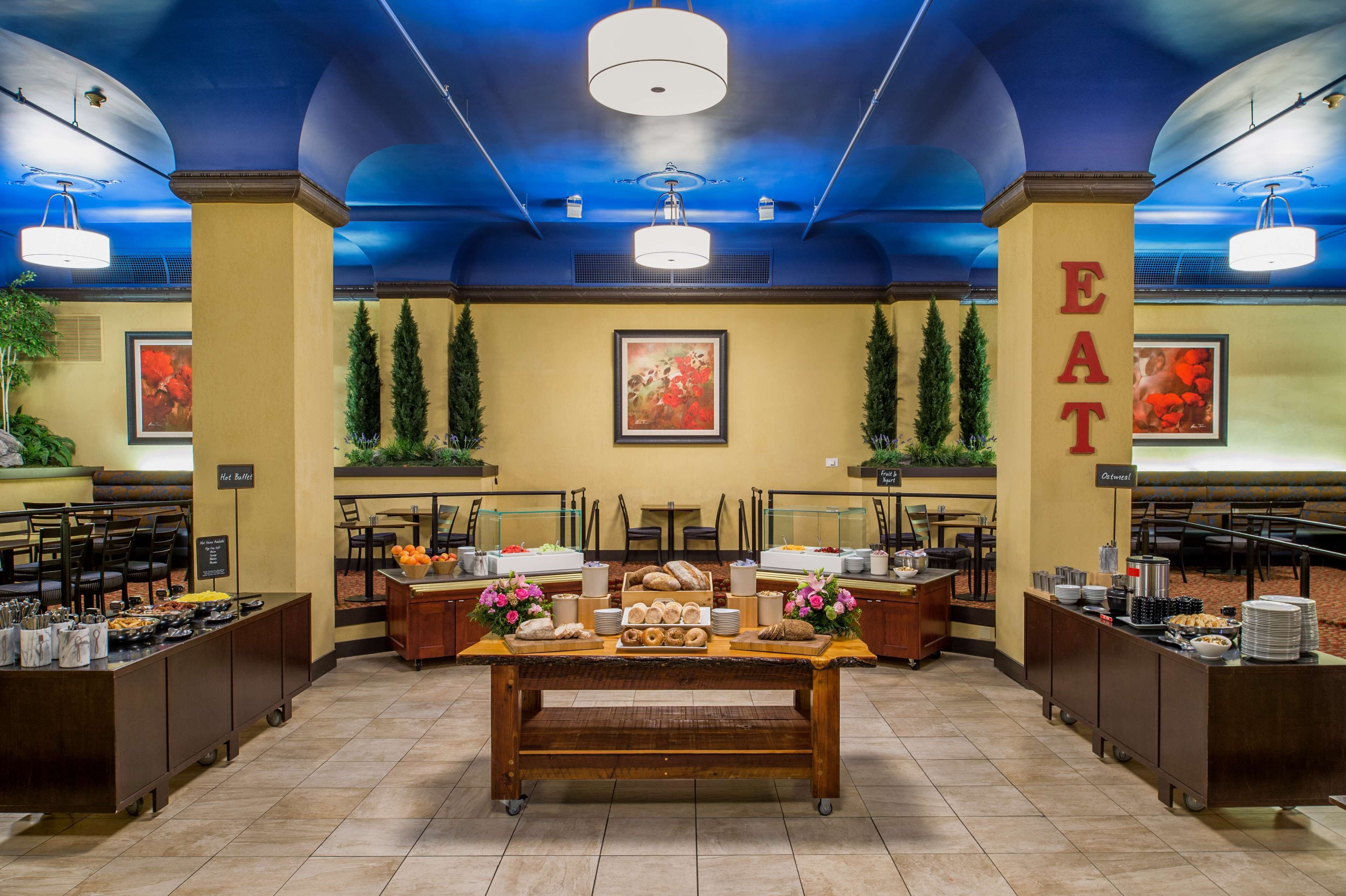 A buffet setup with various food items and a central table.