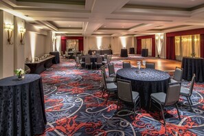 A conference room with round tables, chairs, and a carpeted floor. - Embassy Suites by Hilton Portland Downtown (Portland)