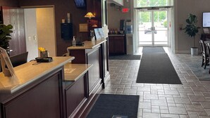 A hotel reception area with a reception desk, a large window, and a chandelier. - Days Inn by Wyndham Lisbon (Lisbon)