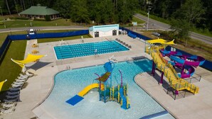 A swimming pool with multiple lanes, a water slide, and a water park area. - Four Points by Sheraton Fayetteville Fort Bragg (Fayetteville)