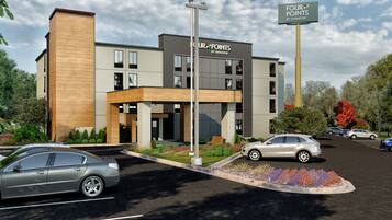 Un edificio moderno con un letrero que dice "Four Points by Sheraton".