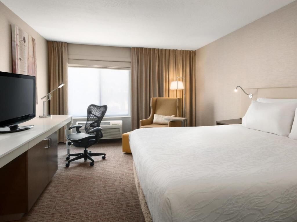 Premium bedding, desk, laptop workspace, blackout drapes