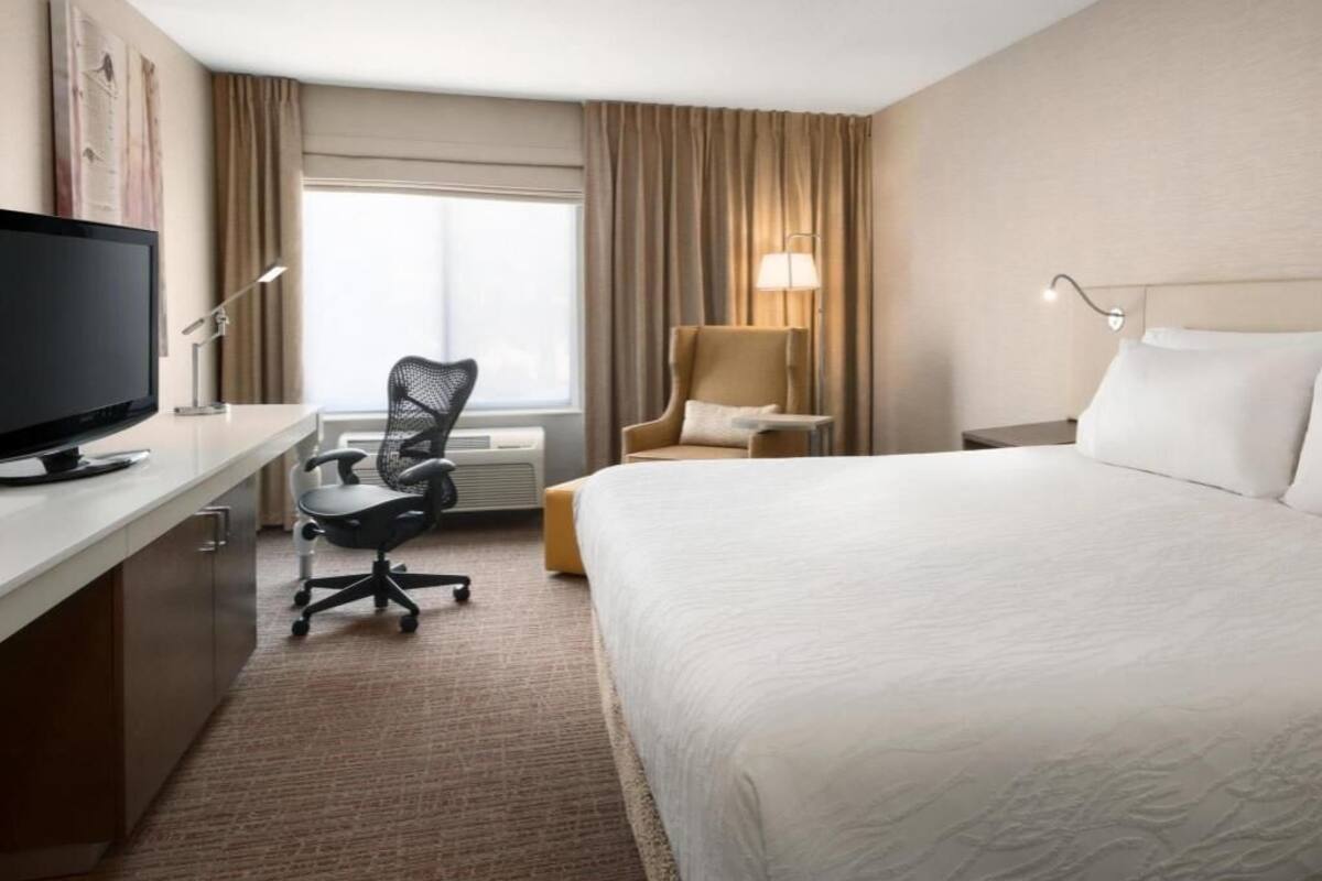 Premium bedding, desk, laptop workspace, blackout drapes