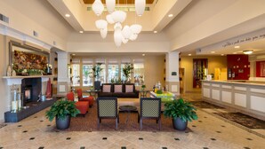 A spacious lobby with a fireplace, seating area, and a reception desk. - Hilton Garden Inn - Flagstaff (Flagstaff)