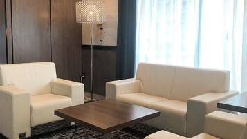 Una sala de estar moderna con un juego de sofá, una mesa de centro y una lámpara de pie.