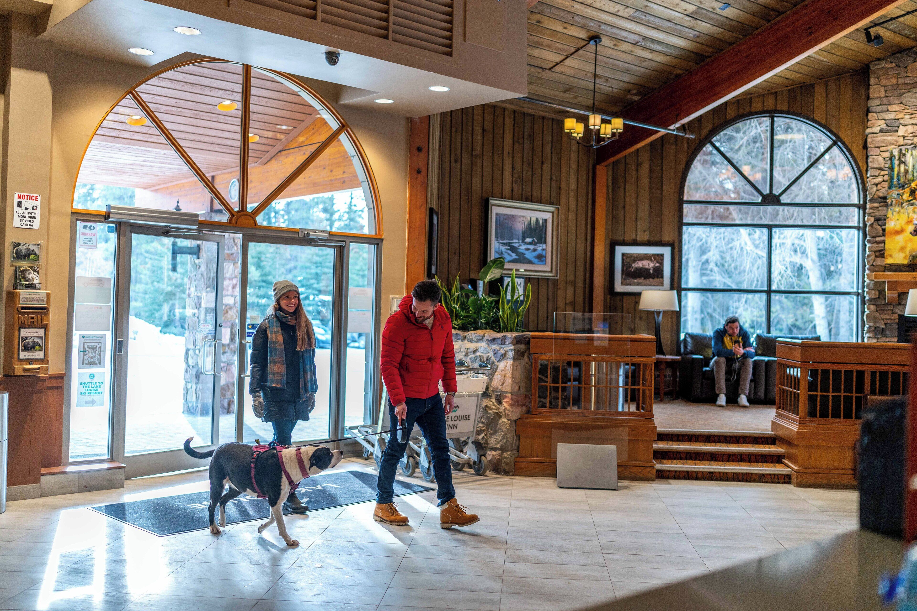 A spacious lobby with a wooden interior, a large arched window, and a reception area.
