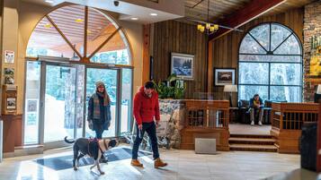 A spacious lobby with a wooden interior, a large arched window, and a reception area.