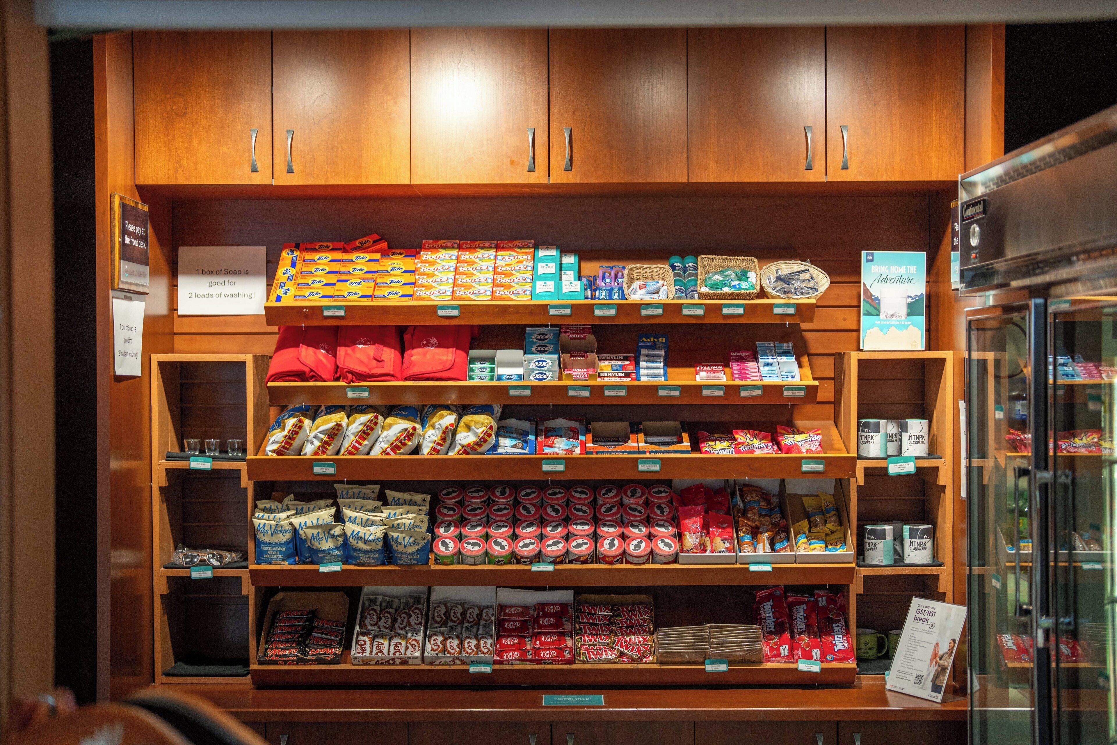 A grocery display with various packaged goods and a coffee machine.