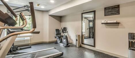 A fitness center with treadmills, an elliptical, and a stationary bike.
