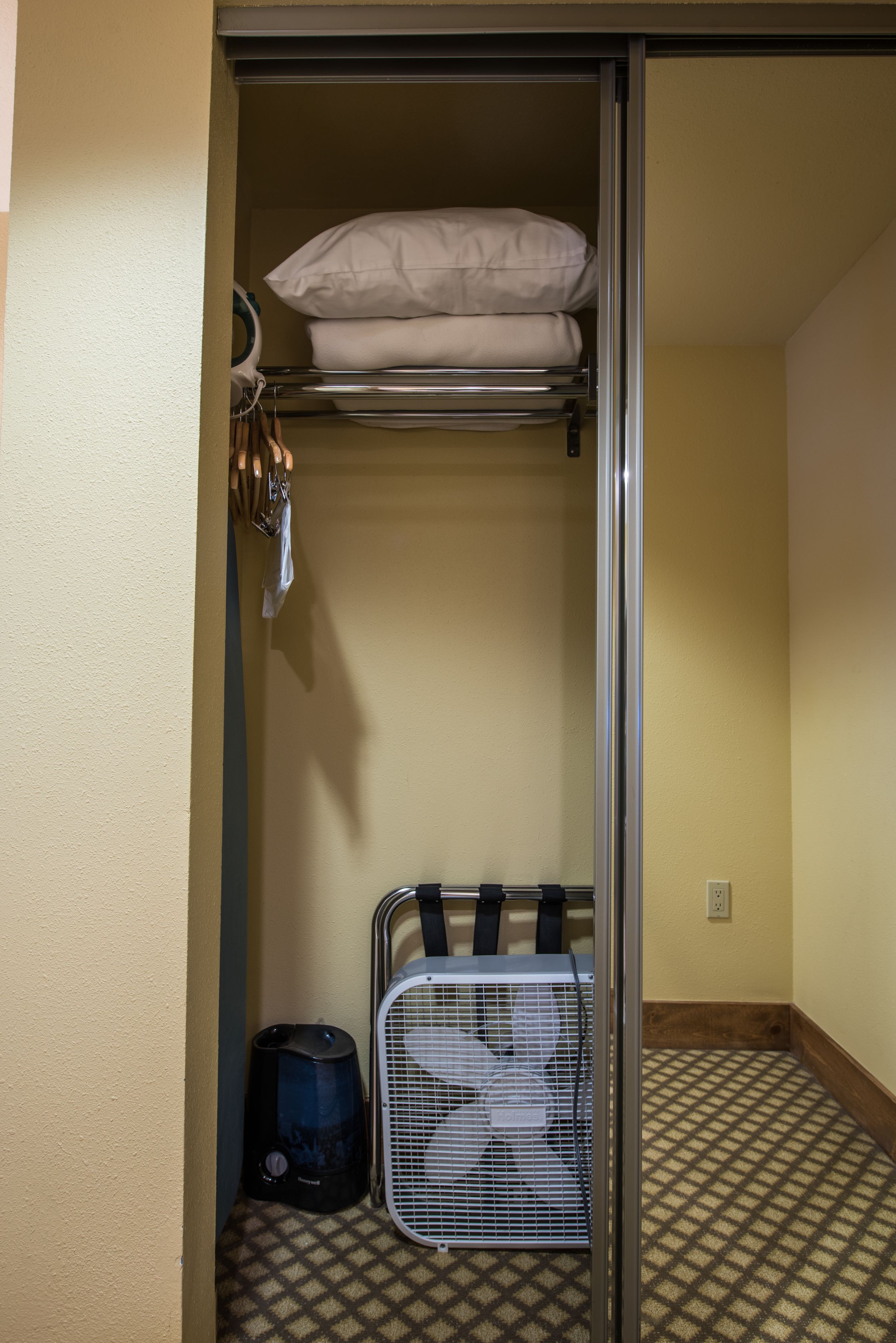 A small, compact room with a bunk bed, a heater, and a luggage rack.