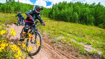 A dirt bike trail with riders in protective gear.