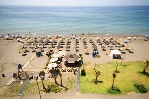 On the beach, sun-loungers, beach umbrellas, beach towels