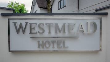 A sign for Westmead Hotel with a modern design.