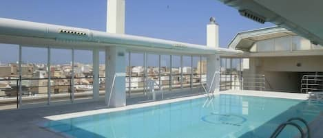 Seasonal outdoor pool, open 10:00 AM to 9:30 PM, pool loungers