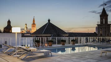 Seasonal outdoor pool, open noon to 9 PM, pool umbrellas, sun loungers