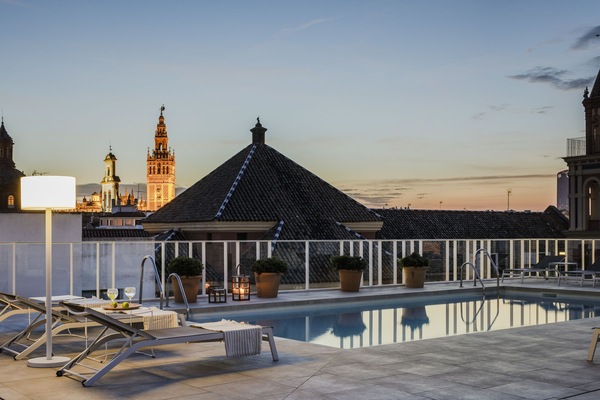 Seasonal outdoor pool, open noon to 9 PM, pool umbrellas, sun loungers