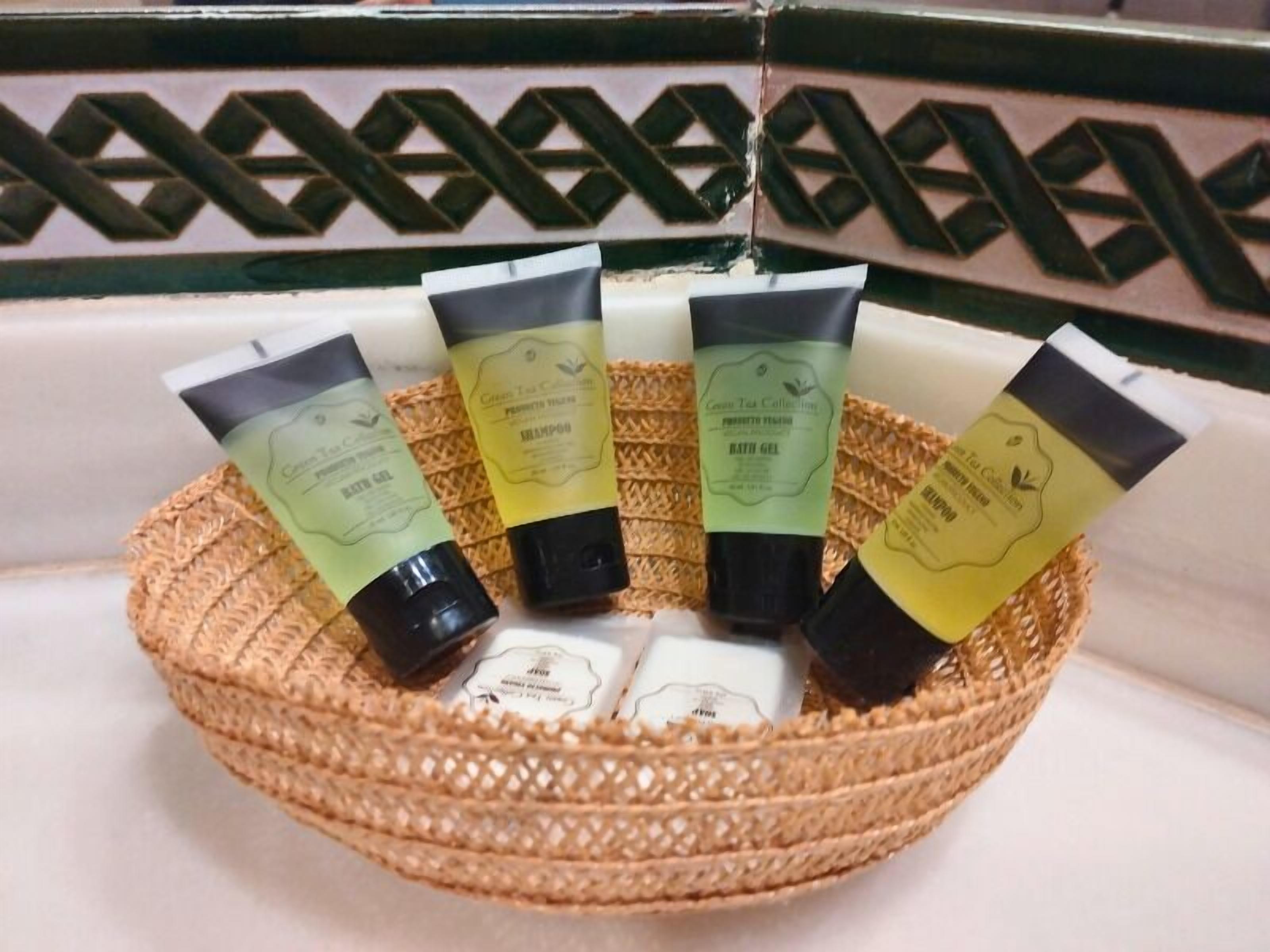 A woven basket containing five tubes of hair care products.
