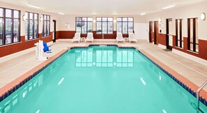 Relax by the pool surrounded by comfortable lounge chairs.