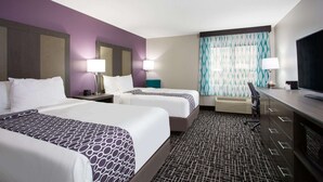 A hotel room with two beds, a desk, a chair, and a television. - La Quinta Inn & Suites by Wyndham Roanoke Salem (Salem)