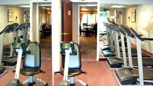 A gym with treadmills, stationary bikes, and exercise chairs. - Aderi Hotel Niantic (Niantic)