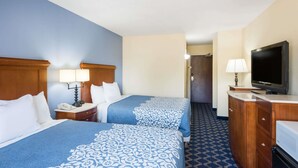 A hotel room with two beds, a TV, a desk with a lamp, and a bathroom visible in the background. - Aderi Hotel Niantic (Niantic)