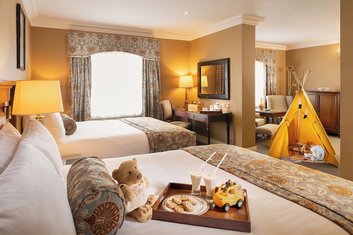 junior suite | in-room safe, desk, blackout curtains, iron/ironing board