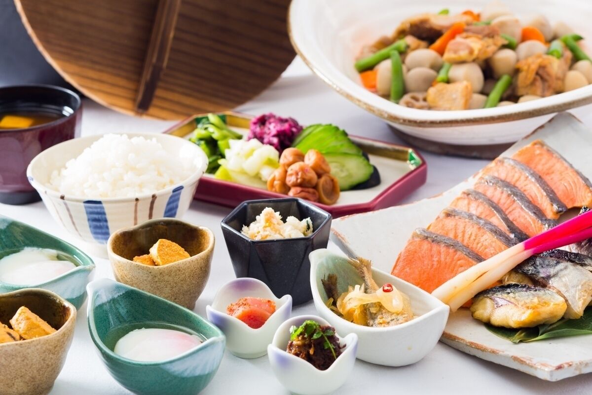 A variety of dishes including salmon, rice, and vegetables, suggesting a meal setting.