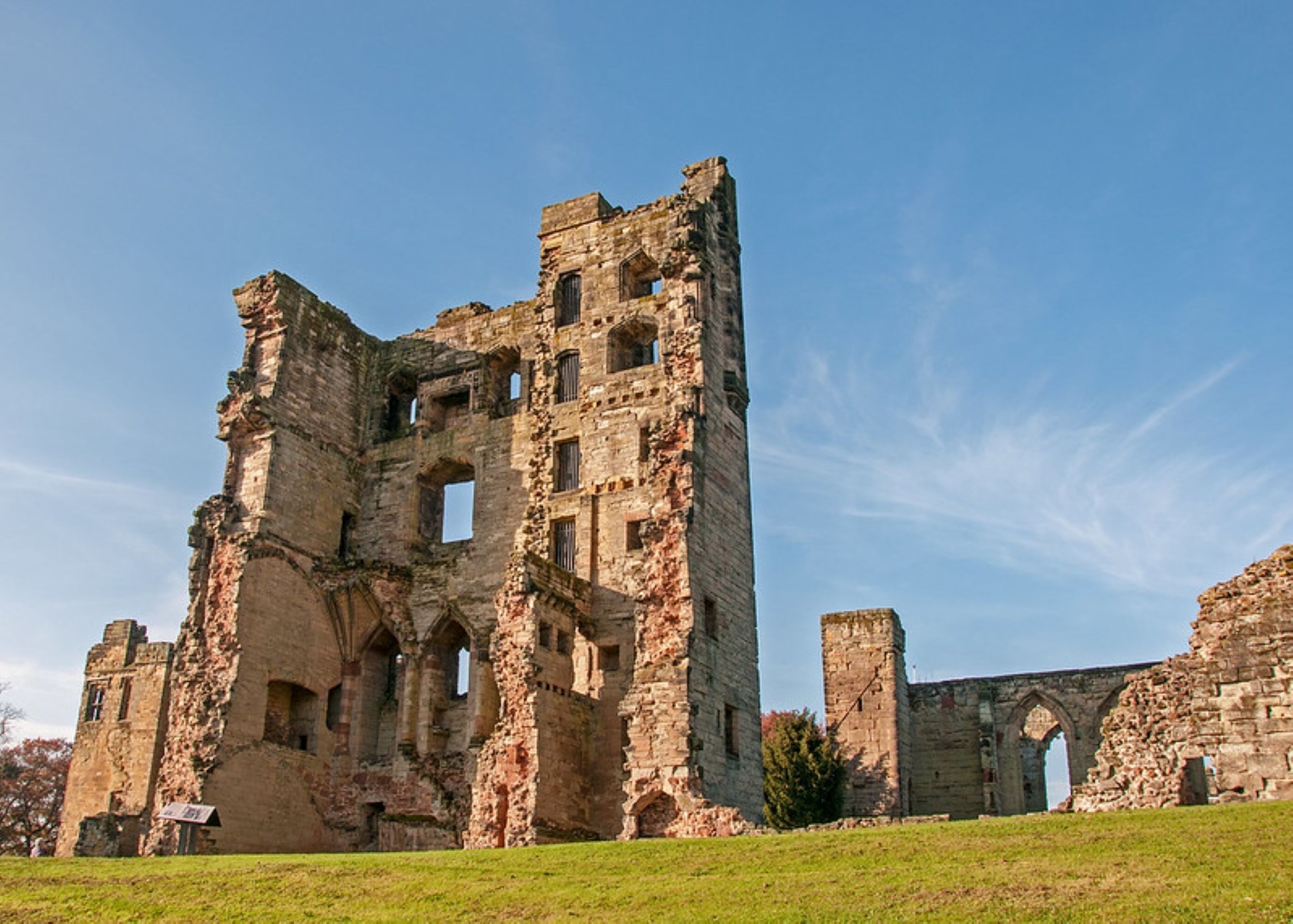 An ancient stone structure with multiple arches and ruins.