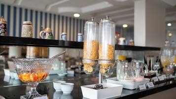 A breakfast buffet with various food items and containers.