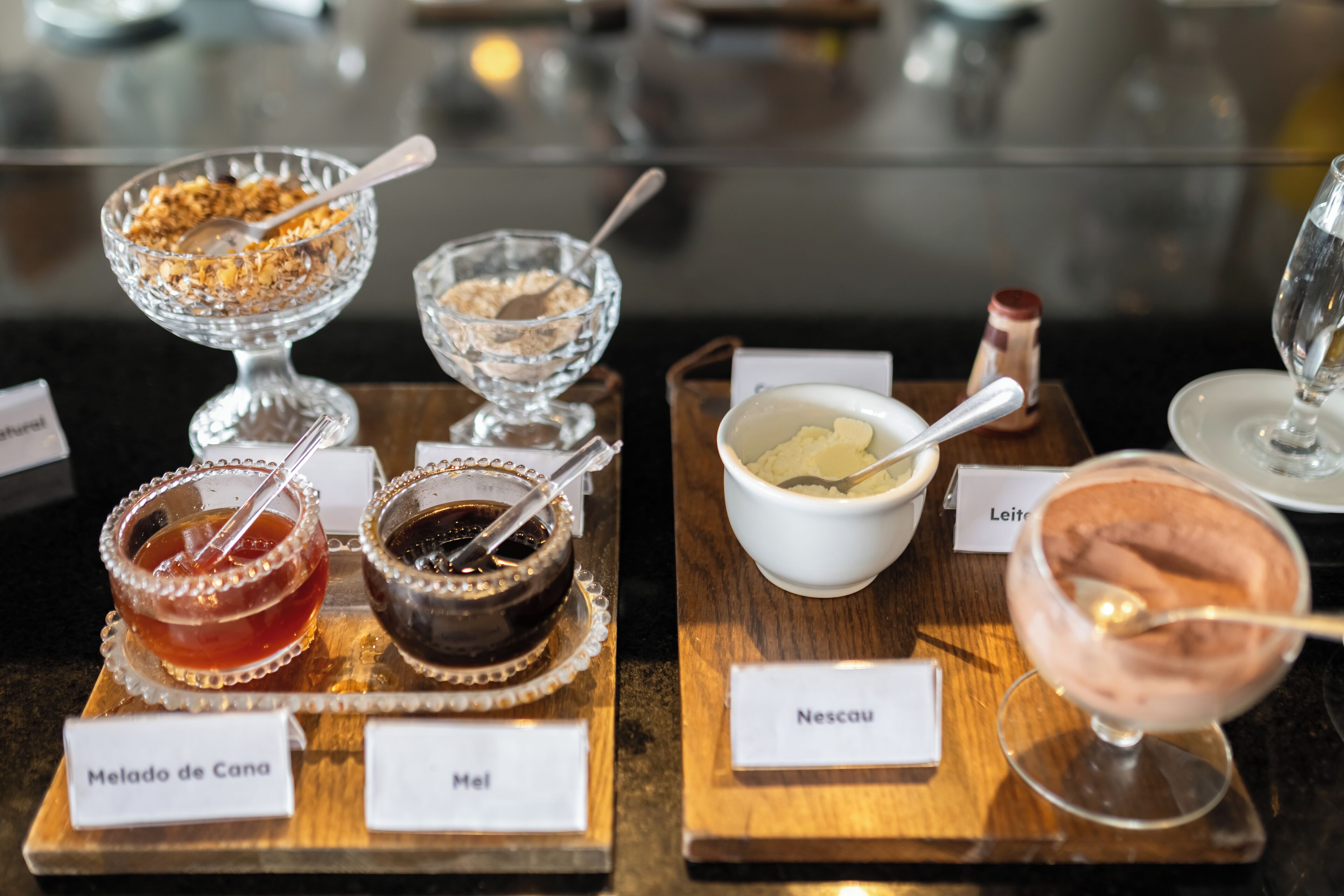 Eine Auswahl an Desserts auf einer Holzbrett mit Beschriftungen.