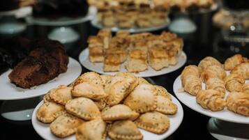 A variety of pastries on plates, including croissants and other baked goods.