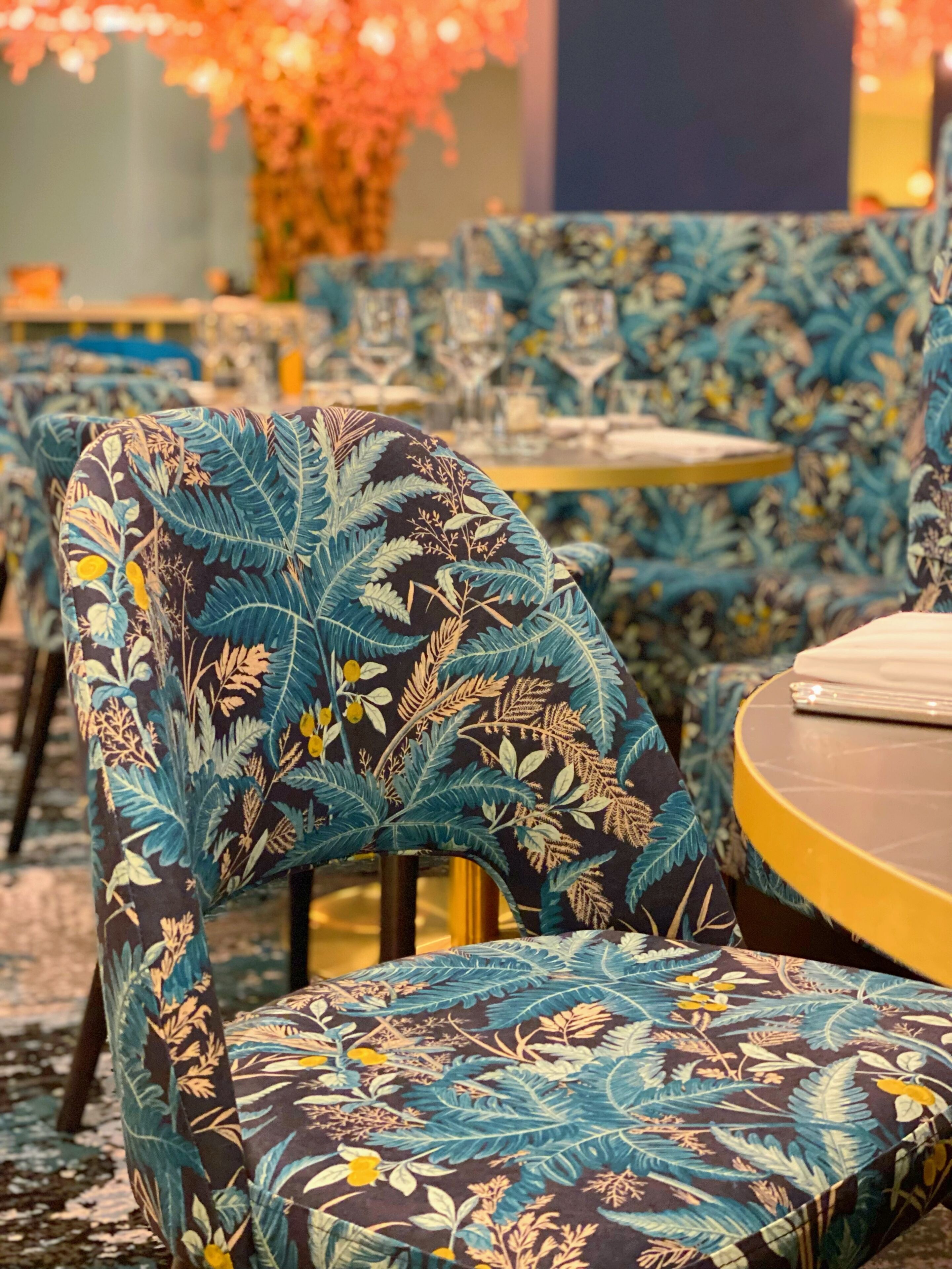 A dining area with patterned chairs and tables.