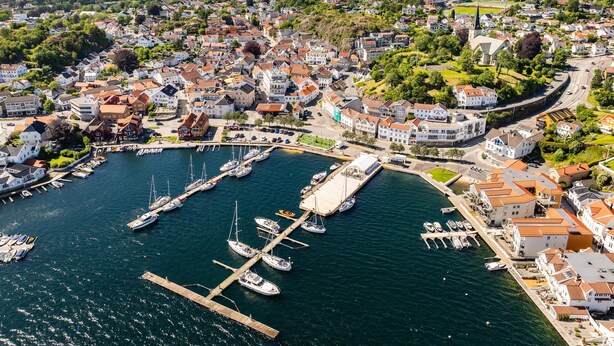 A coastal town with a marina, houses, and a church. - Home Hotel Grimstad (Grimstad)