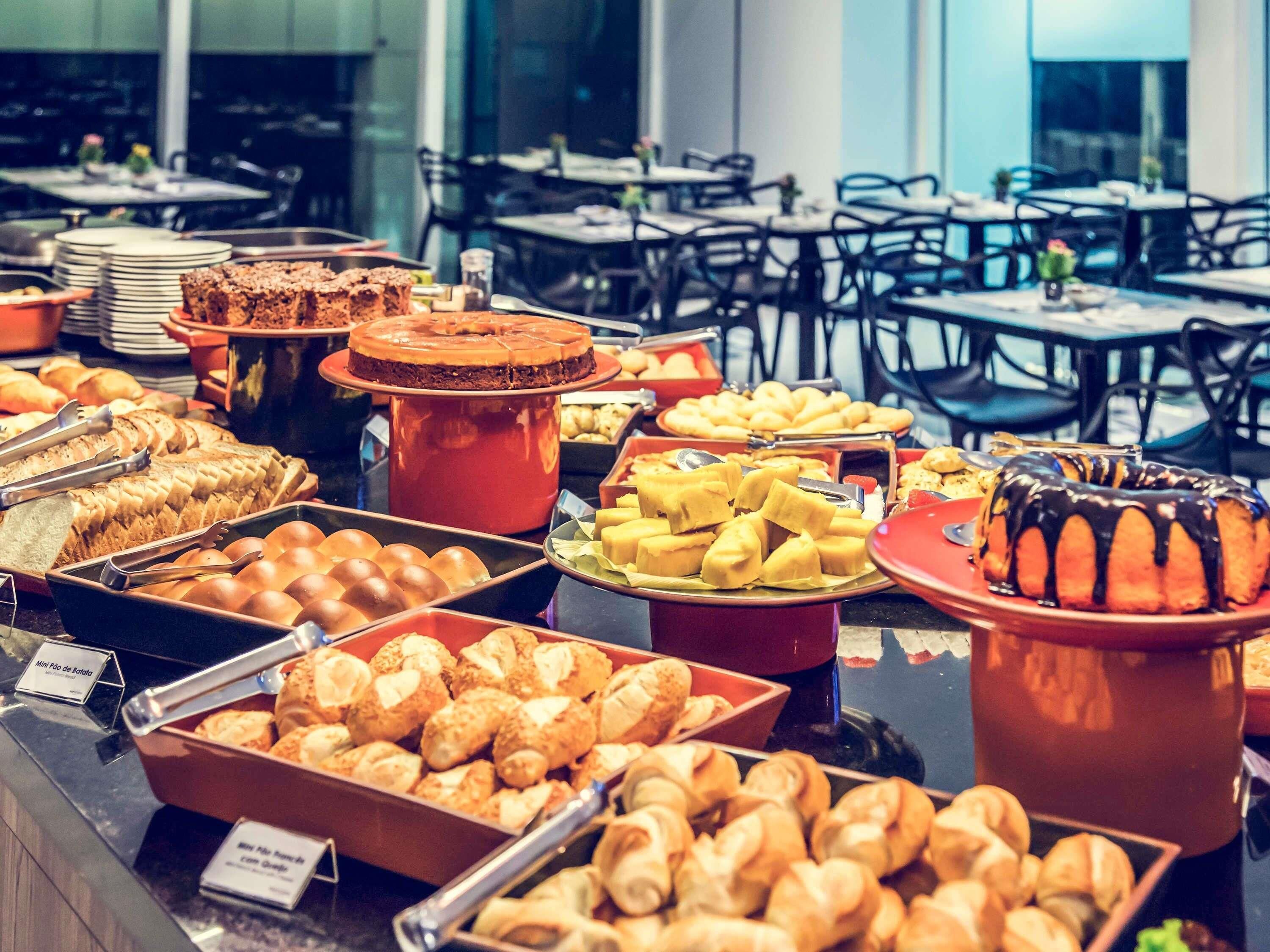 A buffet with various baked goods and pastries.