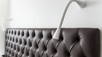 A tufted headboard with a curved white handle.