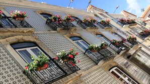 A building with patterned tile facades, multiple balconies with flower boxes, and a visible hotel sign. - Hotel Solaris (Setubal)