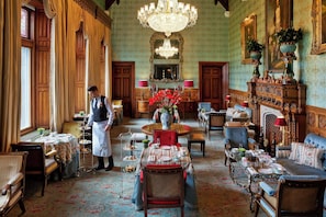 Guests can dine in style in this elegant dining room, surrounded by ornate furniture and fine table settings.