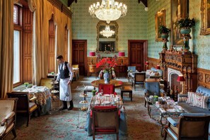 Guests can dine in style in this elegant dining room, surrounded by ornate furniture and fine table settings.