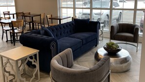 A modern interior with a sectional sofa, a round coffee table, and a small side table.