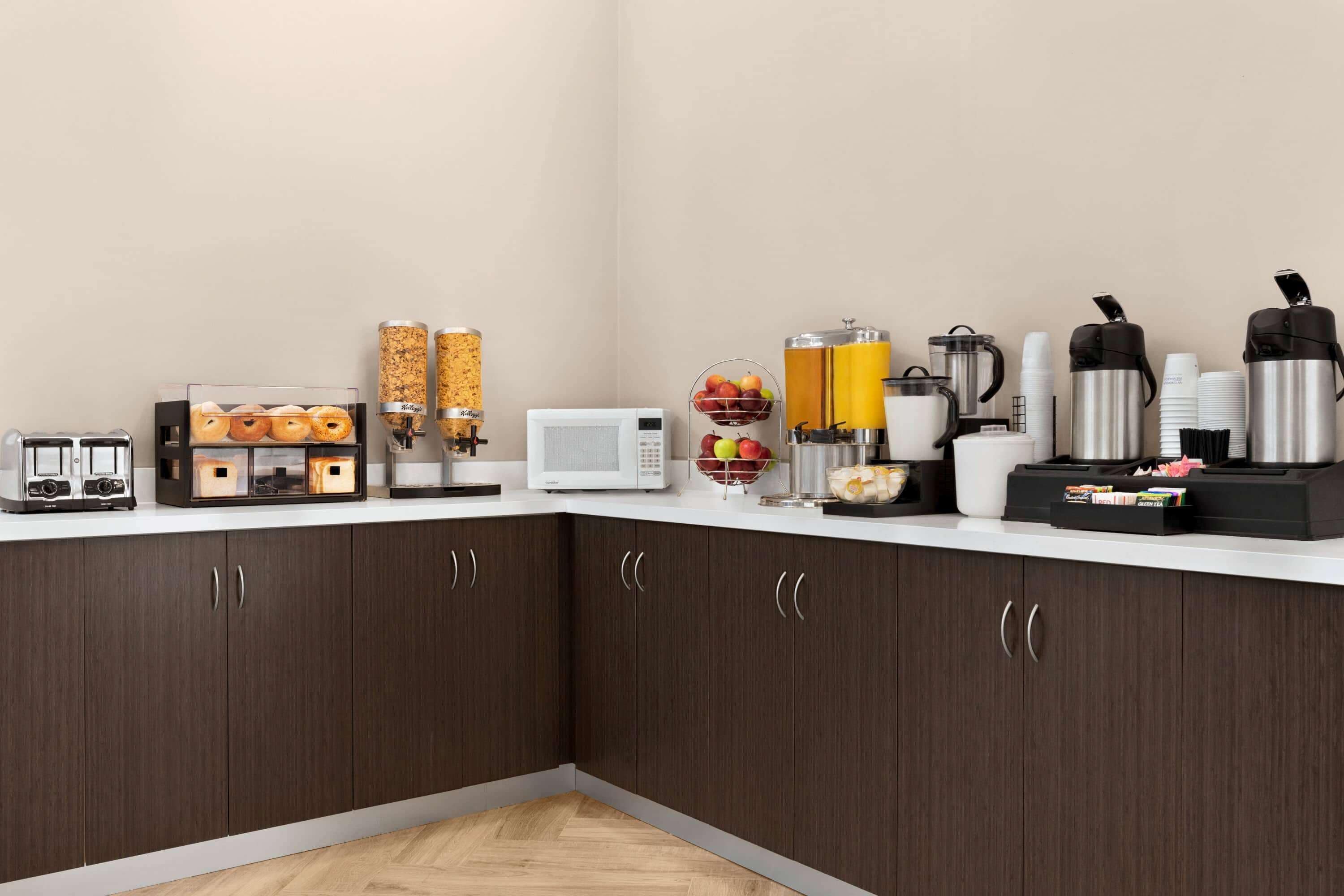 A modern kitchen with a microwave, coffee maker, and various appliances.